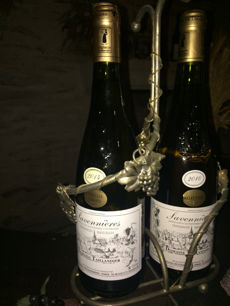 White wine bottles with Savennieres labels on a metal display rack