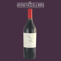 Wine bottle with red foil cap and dark glass, cream label with vertical text