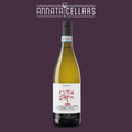 White wine bottle with tall dark glass, yellow liquid, and white label with red motif