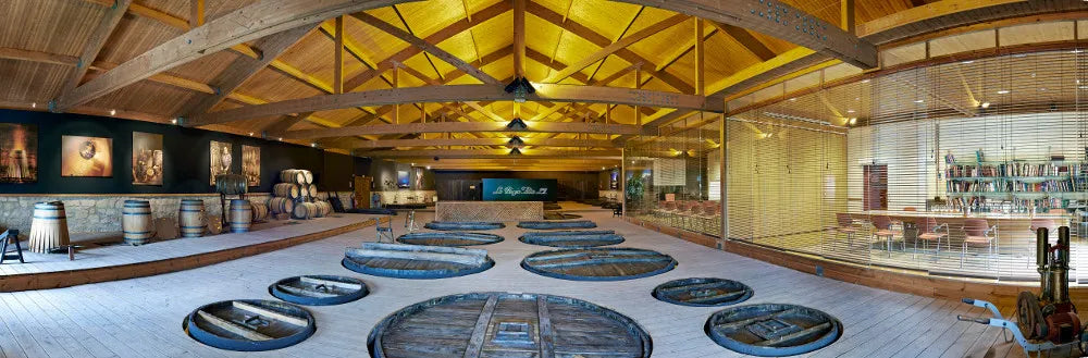 Gran Reserva wine cellar with barrels and tasting-room seating