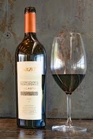 Wine bottle and stemmed glass with dark red wine