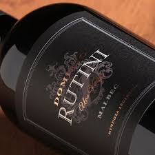 Black wine bottle label close-up with Rutini Dominio Malbec text