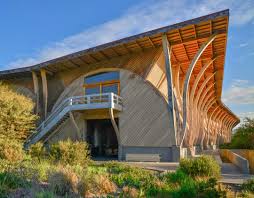 Carmenere red wine winery building exterior with arched wood facade