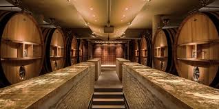 Winery barrel storage aisle with rows of wooden casks along both sides