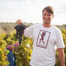 White T-shirt with Annata Cellars logo worn by a man outdoors