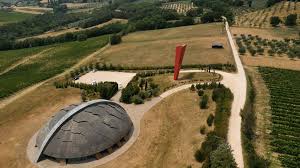 Wine vineyard with curved cellar dome and grape rows