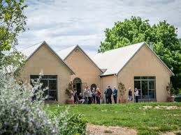 Winery building with group gathered on lawn