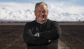 Malbec wine portrait of a smiling man outdoors with arms crossed