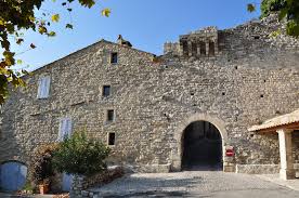 Stone winery building with arched entrance and courtyard