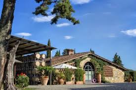Tuscany stone winery building with outdoor patio and potted plants
